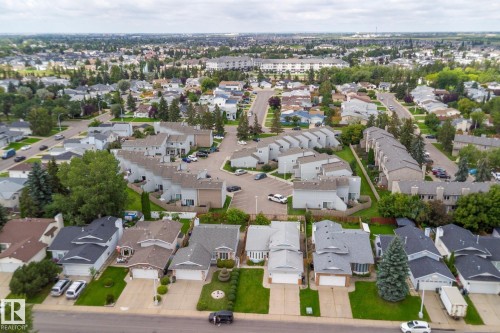 Residential neighborhood featuring various architectural styles, mature trees, and paved roads - 17724 94 Street Nw, Edmonton, AB 