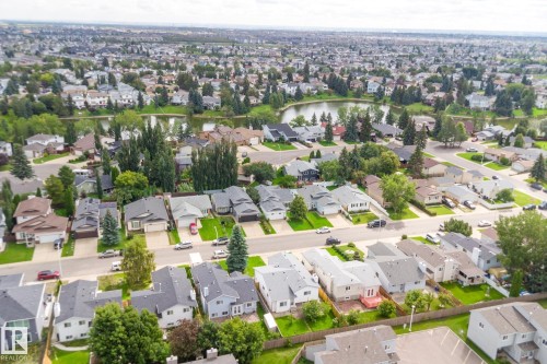 Residential neighborhood with a prominent body of water, extensive tree coverage, and a network of paved streets - 17724 94 Street Nw, Edmonton, AB 