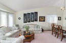 Vaulted ceiling, bay window, light wall tones, carpet flooring, window with sheer curtains - 17724 94 Street Nw, Edmonton, AB 