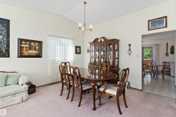 Vaulted ceiling with an overhead light fixture, window with sheer coverings, and an entry opening to another room - 