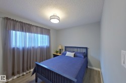 Room featuring wood-finish flooring, light gray wall paint, and a textured white ceiling - 