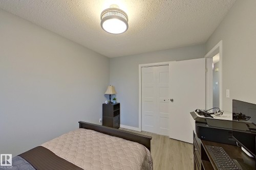 Neutral wall tones complemented by wood-finish flooring - 16 Brunswick Crescent, St. Albert, AB - Indoor Photo Showing Bedroom