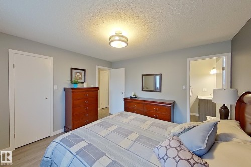 Light gray wall paint complemented by white trim and wood-finish flooring - 16 Brunswick Crescent, St. Albert, AB - Indoor Photo Showing Bedroom