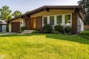 Ranch-style residence featuring a brick and siding facade, a front-facing garage with a paneled door, and a wooden entry door - 16 Brunswick Crescent, St. Albert, AB  - Outdoor 