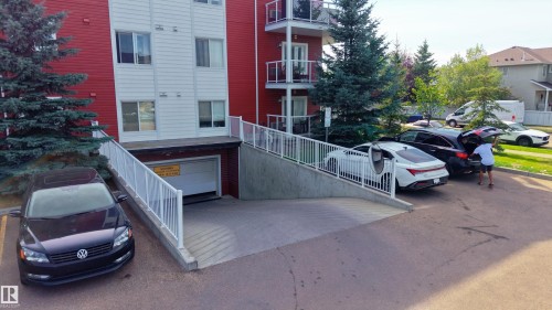 Gated underground parking access with white railing - #302 2229 44 Av Nw, Edmonton, AB 