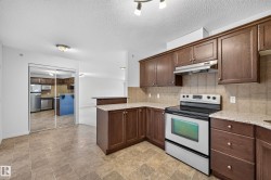 Kitchen featuring wood-finish cabinetry, stainless steel appliances, tiled flooring, and a tiled backsplash - 