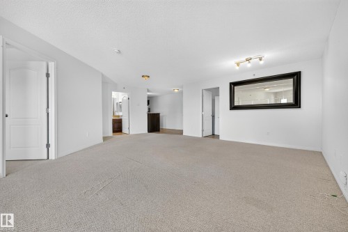Neutral-toned carpet flooring, white walls, and track lighting - #6430 7331 South Terwillegar Dr Nw, Edmonton, AB 