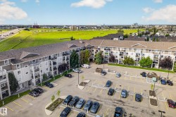 Multi-story residential building with private balconies and exterior parking - 