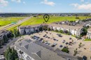 Multi-story residential buildings featuring balconies, surface parking, and surrounding green spaces - #6430 7331 South Terwillegar Dr Nw, Edmonton, AB 
