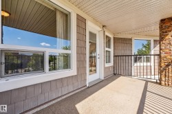 Outdoor balcony with concrete flooring, accented by a stacked stone column - 