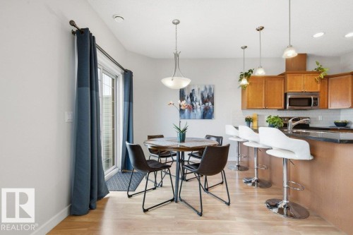 Dining area with wood-finish flooring, glass patio door, and recessed lighting - #17 7293 South Terwillegar Dr Nw, Edmonton, AB - Indoor