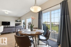 Open-concept living area featuring light wood-finish flooring, vaulted ceilings, and ample natural light from multiple windows - 