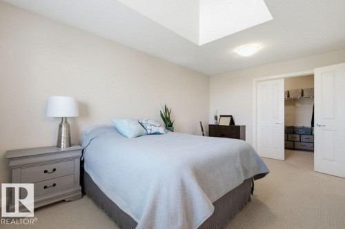 Carpeted room featuring a ceiling-mounted light fixture and a skylight - #17 7293 South Terwillegar Dr Nw, Edmonton, AB - Indoor Photo Showing Bedroom
