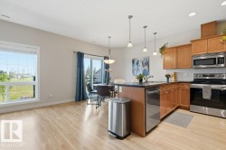 Kitchen featuring wood cabinetry, stainless steel appliances, dark countertops, and a subway tile backsplash - 