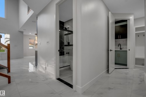 Modern interior featuring light-toned walls and polished tile flooring throughout - 4005 39 Street, Beaumont, AB - Indoor Photo Showing Other Room