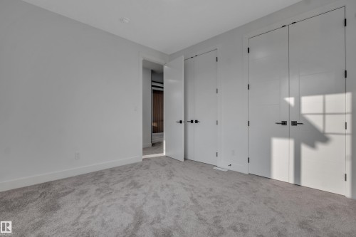 Spacious room featuring light gray carpeting and white walls - 4005 39 Street, Beaumont, AB - Indoor Photo Showing Other Room