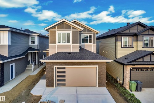 Contemporary home featuring a neutral color palette, stone facade, and horizontal siding - 4005 39 Street, Beaumont, AB - Outdoor