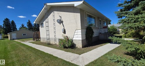 Stucco exterior with a pitched roof - 5706 52 Street, Vegreville, AB 