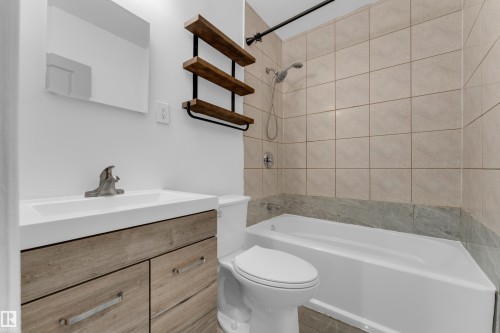 Vanity with wood-finish cabinetry, integrated sink, and brushed nickel faucet - 12116 81 Street Nw, Edmonton, AB 
