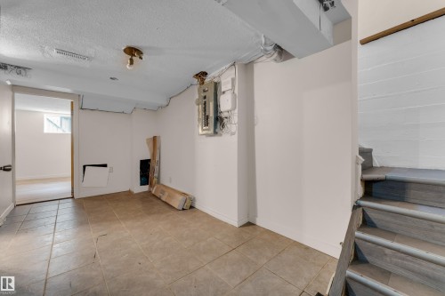 Tiled flooring extending into a separate room - 12116 81 Street Nw, Edmonton, AB 