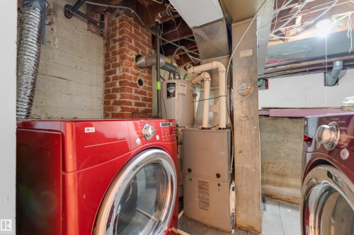 Utility area featuring exposed brick, concrete foundation walls, and various mechanical systems - 12116 81 Street Nw, Edmonton, AB 