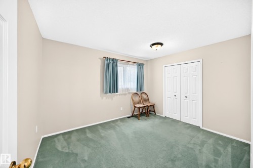 Light green carpeting with light-toned walls and a window - 4327 49 Street Nw, Edmonton, AB 