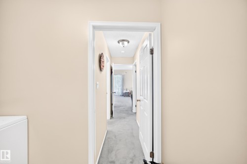 Bright hallway with clean white trim, recessed ceiling lighting, and neutral wall finishes - 4327 49 Street Nw, Edmonton, AB 