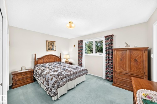 Light-toned walls with textured ceiling, recessed window, and light blue carpet - 4327 49 Street Nw, Edmonton, AB 