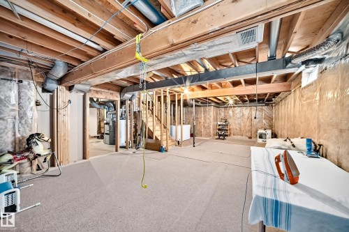 Unfinished lower level featuring exposed ceiling joists, insulated walls, and structural wood framing for future development - 4327 49 Street Nw, Edmonton, AB 