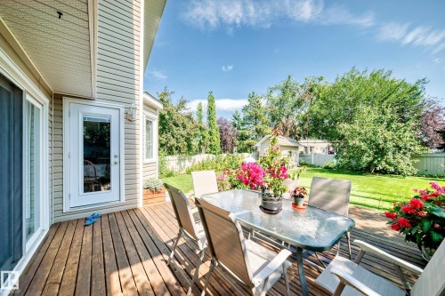 Expansive composite deck featuring wood-finish flooring and direct access to the home's interior - 4327 49 Street Nw, Edmonton, AB 