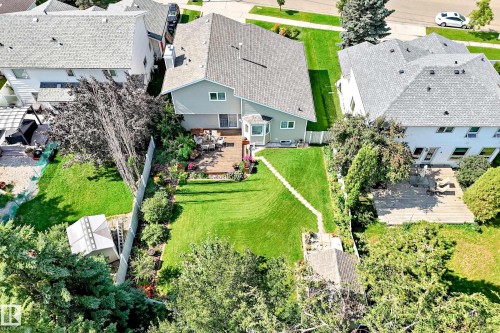 Expansive backyard featuring a large wood deck, mature trees, and a storage shed - 4327 49 Street Nw, Edmonton, AB 