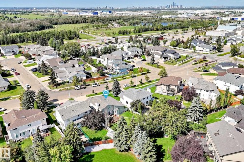 Residential neighborhood with mature trees, established streets, and distant city skyline - 4327 49 Street Nw, Edmonton, AB 