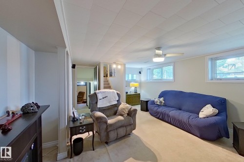 Finished Basement Recreation Room featuring exposed beam ceiling detail, recessed lighting, carpeted flooring, and ample space for multiple functional zones - 14 Brunswick Crescent, St. Albert, AB 