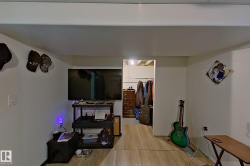 Versatile multipurpose room featuring wood-finish flooring, recessed ceiling lighting, and ample wall space - 14 Brunswick Crescent, St. Albert, AB 