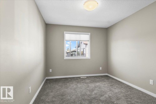 Soft gray carpet flooring, neutral painted walls, and a white-framed window - 1807 Westerra Loop, Stony Plain, AB 