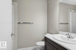 White vanity countertop with an integrated oval sink and chrome faucet - 