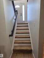 Staircase with wood-finish treads and white risers - 