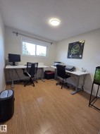 Recessed ceiling light, white window trim, wood-finish flooring, and light wall finishes - 