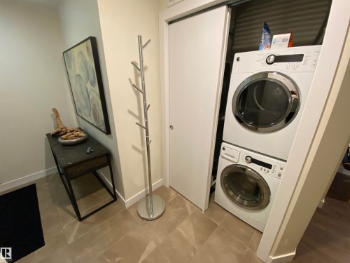 Built-in stackable washer and dryer, tile flooring, and a contemporary console table - #308 9907 91 Av Nw, Edmonton, AB 
