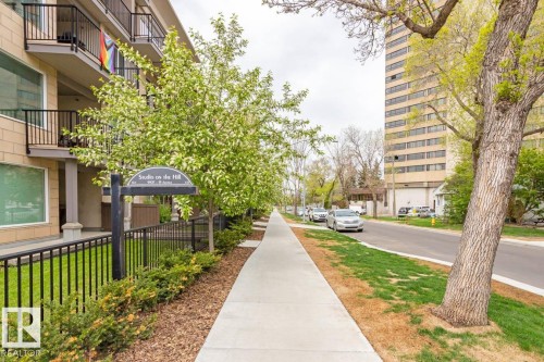 Building exterior with stacked balconies and black metal railings - #308 9907 91 Av Nw, Edmonton, AB 