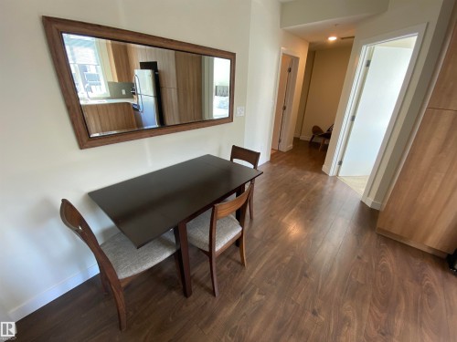 Wood-finish flooring throughout, light neutral wall color, and recessed lighting - #308 9907 91 Av Nw, Edmonton, AB 