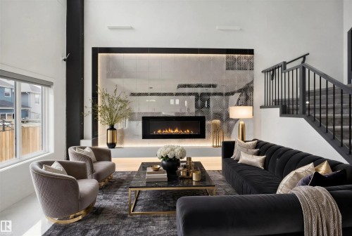 Integrated linear fireplace, patterned feature wall, staircase with black railings, large window, and high ceilings - 2027 13 Avenue Nw, Edmonton, AB 
