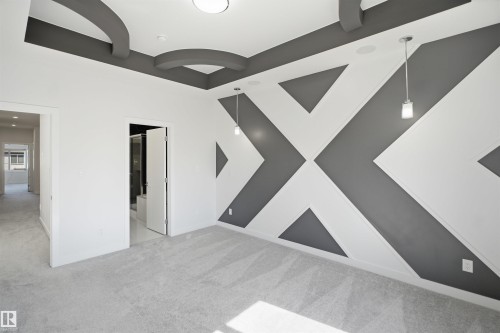 Geometric accent wall with recessed lighting and pendant fixtures - 2027 13 Avenue Nw, Edmonton, AB 