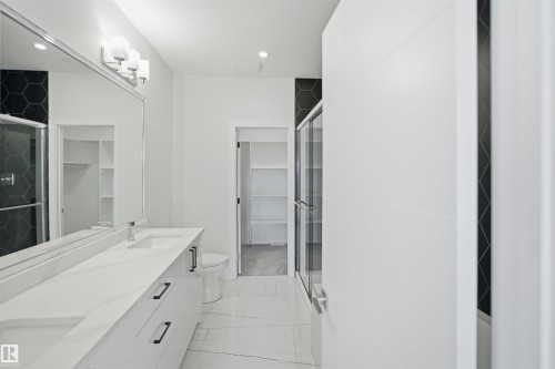 Double vanity with integrated sinks and black cabinet hardware - 2027 13 Avenue Nw, Edmonton, AB 