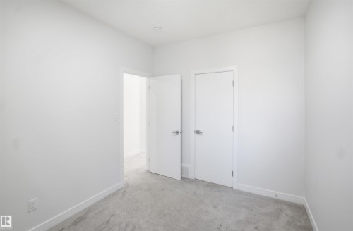 Light gray carpet flooring and white painted walls - 2027 13 Avenue Nw, Edmonton, AB 