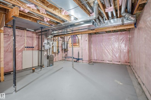Unfinished basement with exposed ceiling joists and ductwork, supported by structural posts - 2027 13 Avenue Nw, Edmonton, AB 