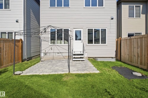 Rear exterior with light-colored siding and white trim - 2027 13 Avenue Nw, Edmonton, AB 