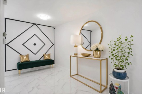 White marble-look flooring, accent wall with geometric molding, recessed ceiling light, and a built-in console table with a gold-framed mirror - 2027 13 Avenue Nw, Edmonton, AB 