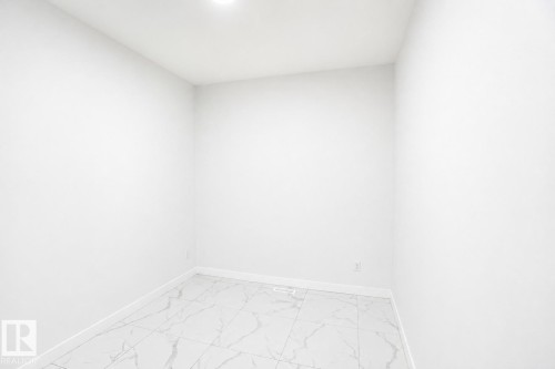 Recessed lighting, light-toned walls, and large format tile flooring - 2027 13 Avenue Nw, Edmonton, AB 