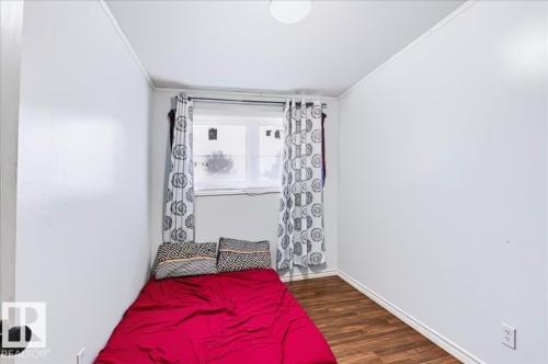 Wood-finish flooring with white painted walls and a flush-mount ceiling light - 12919 135 Avenue Nw, Edmonton, AB 